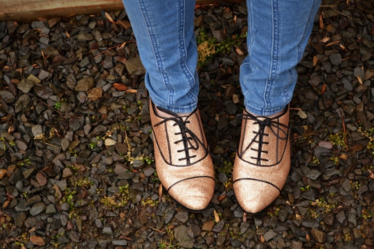 Lace Up Flat Gold Shimmer Shoes lace up flat shoes shown against gravel