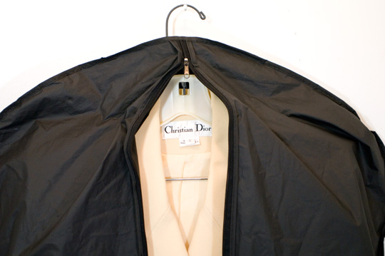 garment bag over a christian dior suit
