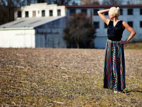 a young woman wearing a vintage skirt in a field