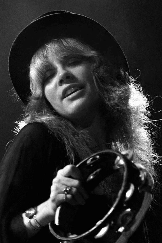 Nicks performing in 1978, wearing a hat