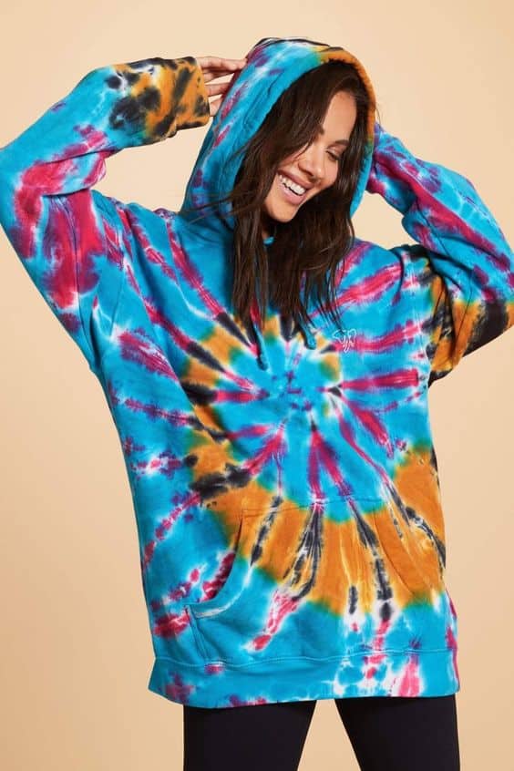 A model posing in tie dye clothes.