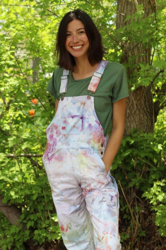 A woman in a tie dye overalls.