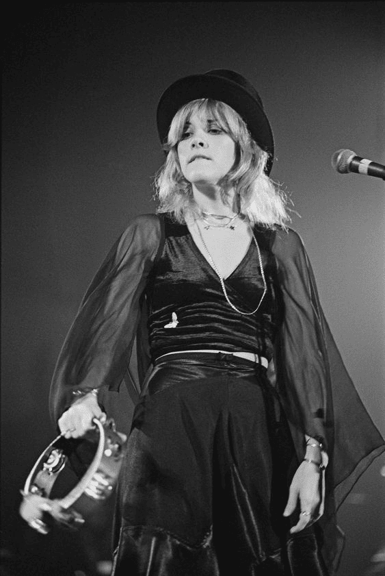 Nicks in a black dress performing in the 70s